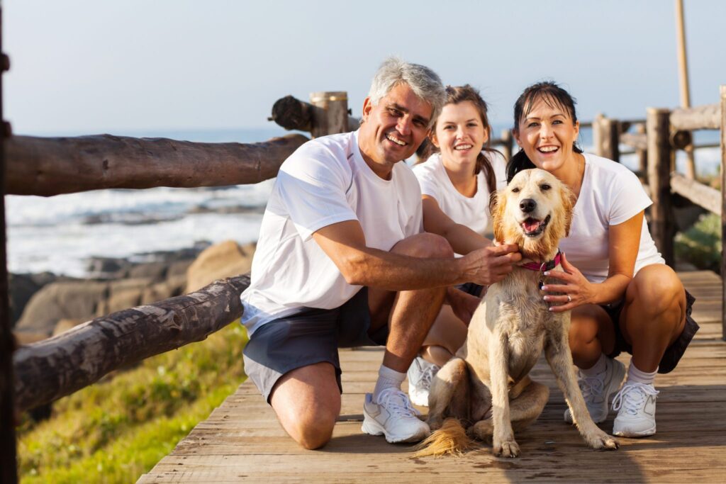 sporty family and pet dog at the beach